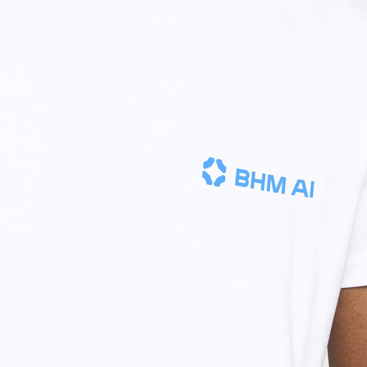 A white Birmingham AI T-shirt with the BHM AI lockup on the chest in bright blue