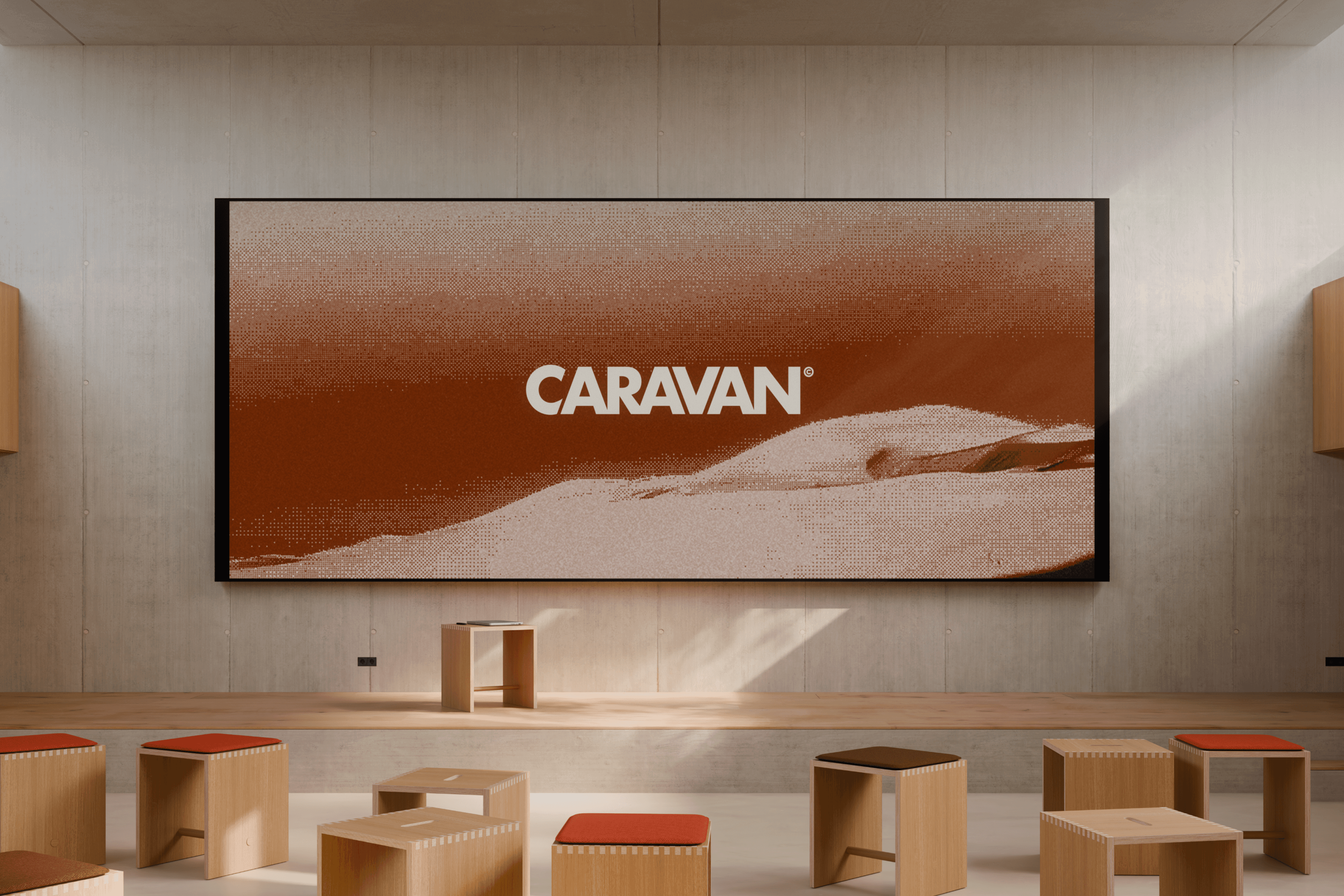 Caravan brand shown on a training-room wall screen